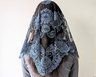 May include: A black lace veil with a blue floral pattern. The veil is worn over the head and falls down the back.