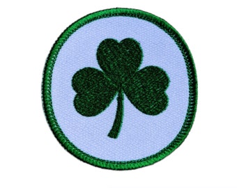 May include: A green shamrock embroidered on a white circle with a green border. The patch is perfect for adding a touch of Irish pride to clothing, bags, or crafts.