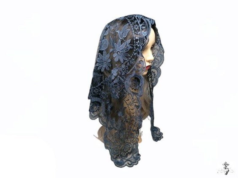 Puede incluir: Una mantilla de encaje negro con un patr&oacute;n floral. El encaje es delicado y tiene un brillo sutil. La mantilla es un tocado tradicional que usan las mujeres en algunas culturas.