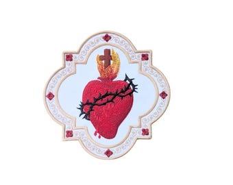 May include: Embroidered patch with a red heart pierced by thorns and a cross on top, surrounded by a beige frame with a white background.