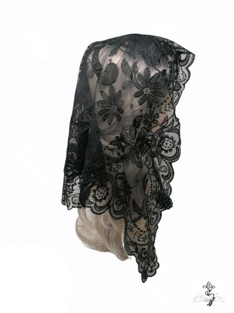 May include: Black lace mantilla with floral embroidery. The lace is delicate and intricate, and the embroidery is detailed and elegant.