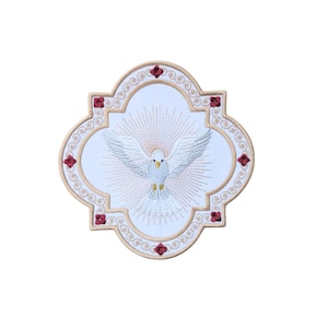 May include: White embroidered dove with golden rays, surrounded by a decorative frame with red jewels, on a white background.