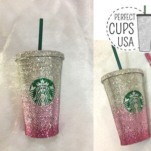 May include: A pink and silver glitter tumbler with a green Starbucks logo and a green straw. The tumbler has the text "PERFECT CUPS USA" on it.
