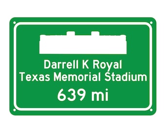 May include: Green road sign with white text and a white silhouette of a stadium. The sign reads "Darrell K Royal Texas Memorial Stadium 639 mi".