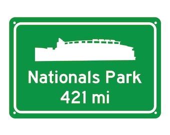 May include: Green road sign with white text and a silhouette of a stadium. The sign reads "Nationals Park 421 mi".