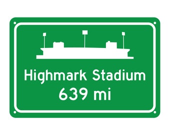 May include: Green road sign with white text and a silhouette of a stadium. The sign reads "Highmark Stadium 639 mi".
