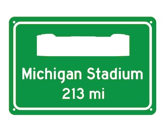 May include: Green road sign with white text and a white silhouette of a stadium. The sign reads "Michigan Stadium 213 mi".