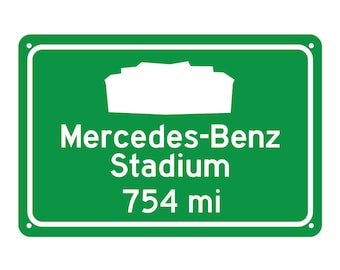 May include: Green road sign with white text and a white silhouette of a stadium. The sign reads "Mercedes-Benz Stadium 754 mi".