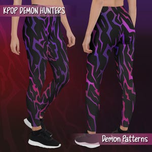 May include: Black leggings with a vibrant pattern of jagged lines in shades of purple and pink. The leggings feature the text "KPOP DEMON HUNTERS" at the top and "Demon Patterns" at the bottom. The leggings are shown on a person.