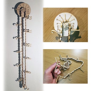 May include: A wooden clock with a chain and numbered links. The clock face is a circle with numbers from 0 to 60. The chain is attached to the clock face and hangs down, with the numbered links hanging from the chain.