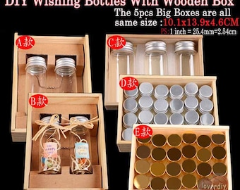 Peut inclure: Cinq boîtes en bois avec couvercles, chacune contenant un ensemble différent de bouteilles en verre ou de couvercles en métal. Les boîtes sont toutes de la même taille : 10,1 cm sur 13,9 cm sur 4,6 cm. Les bouteilles sont en verre transparent et certaines portent des étiquettes avec du texte. Les couvercles sont argentés ou dorés.