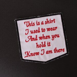 May include: White fabric patch with red embroidered text that reads "This is a shirt I used to wear And when you hold it Know I am there".