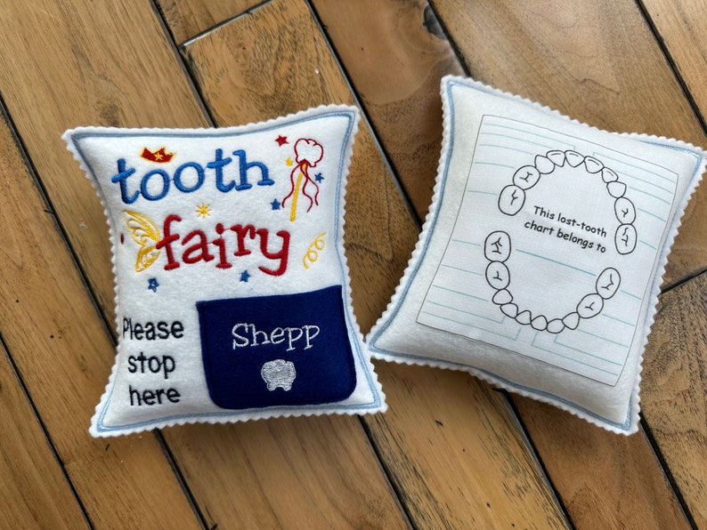 Tooth fairy pillow with embroidered details.  It has a pocket for tooth exchange.  Personalized with the child's name embroidered on the pocket.  In the back it has a tooth chart to keep track of the dates of the lost teeth.