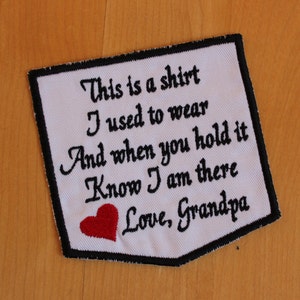 May include: White fabric patch with black embroidered text that reads "This is a shirt I used to wear And when you hold it Know I am there Love, Grandpa". A red heart is embroidered below the text.