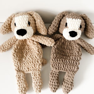 May include: Two crocheted plush dog toys. One is beige and the other is brown. Both have white faces with black eyes and noses.