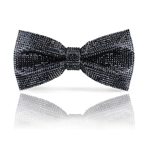 May include: A black bow tie made of small, sparkly sequins. The bow tie is tied and ready to wear.