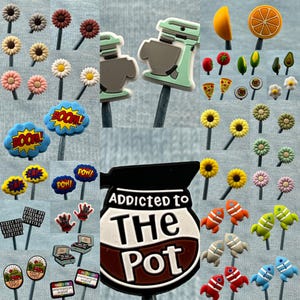 May include: A collection of colorful, whimsical, and fun food-themed charms for decorating coffee mugs, water bottles, or other items. The charms feature images of a coffee pot, a mixer, a pizza slice, a sunflower, a rocket, and more.