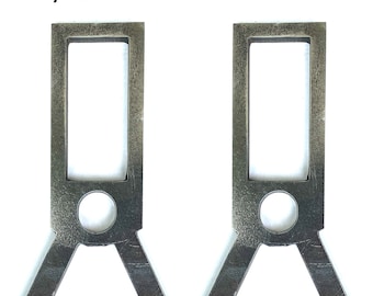 May include: Two silver metal 3/8 inch AR500 steel targets. Each target has a rectangular opening and a round hole in the centre. The targets are shaped like a V at the bottom.