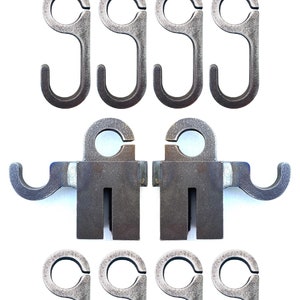 May include: A set of 10 metal hooks, 3/8" AR500, for hanging items. The hooks are silver in color and have a rounded shape. There are two larger hooks with a rectangular base and six smaller hooks.