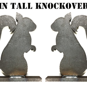 May include: Two 8-inch tall metal squirrel silhouettes on a metal base. The squirrels are facing opposite directions.  The silhouettes are made of metal and have a rustic finish.