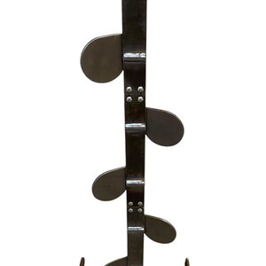 May include: A black metal shooting target stand with five round targets. The stand has a base with two legs and a vertical post with the targets attached.