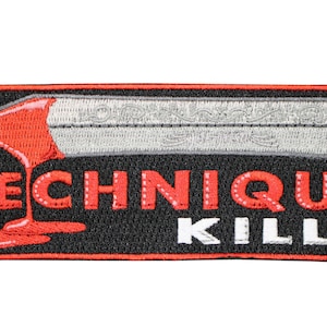 May include: A rectangular embroidered patch with a black background featuring a silver sword blade with intricate scrollwork. A red liquid drips from the blade onto the red text TECHNIQUE, while the word KILLS is embroidered in white.
