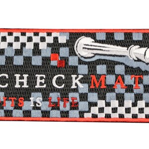 May include: A rectangular embroidered patch featuring a black and grey checkered pattern with a red border. The text CHECKMATE is embroidered in white and red, with JITS IS LIFE in red below. A silver chess king piece is positioned at the top right.