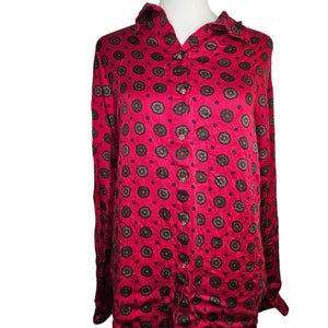 May include: A long-sleeved button-down shirt with a red background and a brown and blue floral pattern.