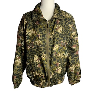 May include: A green, brown, and white floral print jacket with a zipper closure. The jacket has a leopard print pattern throughout.