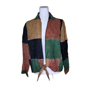 May include: A multi-colored suede jacket with a tie front. The jacket is made of four different colors: brown, red, green, and black.