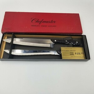 May include: A vintage Chefmaster Kitchen Delite cutlery set in a red box. The set includes a large carving knife and a serrated knife, both with stainless steel blades and black handles. The box reads "WORLD'S FINEST CUTLERY".