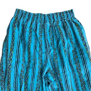 K&ouml;nnte beinhalten: Blaue und gr&uuml;ne gestreifte Hose mit geometrischem Muster. Die Hose hat einen elastischen Bund.