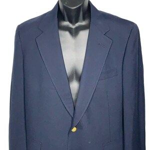 May include: A navy blue blazer with a single gold button.