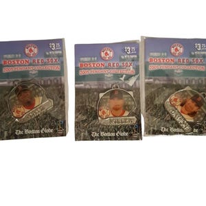 May include: Three Boston Red Sox 2005 Pendant Collection pendants. Each pendant features a baseball player's image and is packaged on a card with the text "BOSTON RED SOX 2005 PENDANT COLLECTION" and "The Boston Globe".