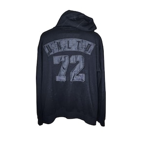 May include: Black hooded sweatshirt with the text "UNITED" and the number "72" in a large, bold font on the back.