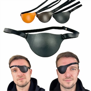 May include: A black leather eye patch with an adjustable strap. The eye patch is shown on a model wearing it over their right eye.