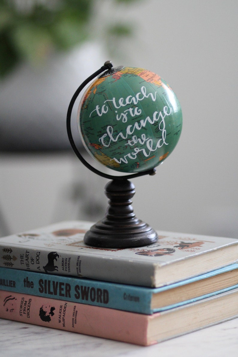 Teacher gift globes reading "to teach is to change the world