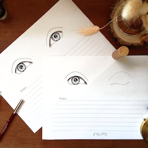 May include: Three printable eye drawing templates with lined areas for notes. The templates feature different eye shapes and sizes, including a closed eye.