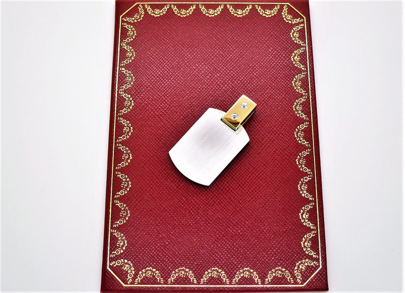 CARTIER "DOG TAG", Santos Dumont Pendant, 18kt Yellow Gold & Brushed Steel with certificate of authenticity.