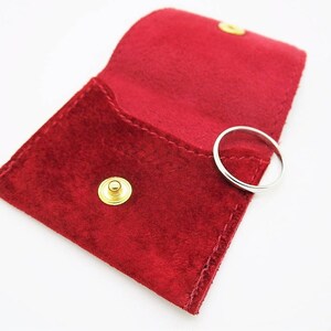 Red suede Cartier pouch for wedding ring.