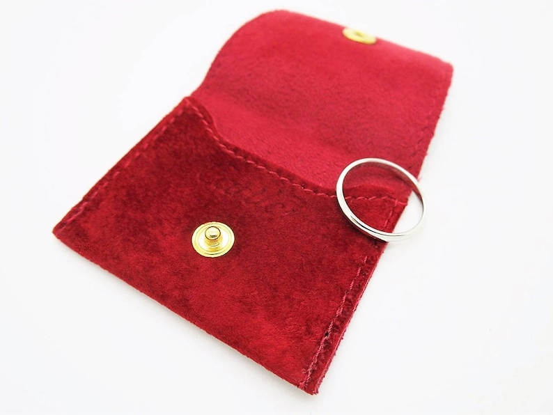 Red suede Cartier pouch for wedding ring.