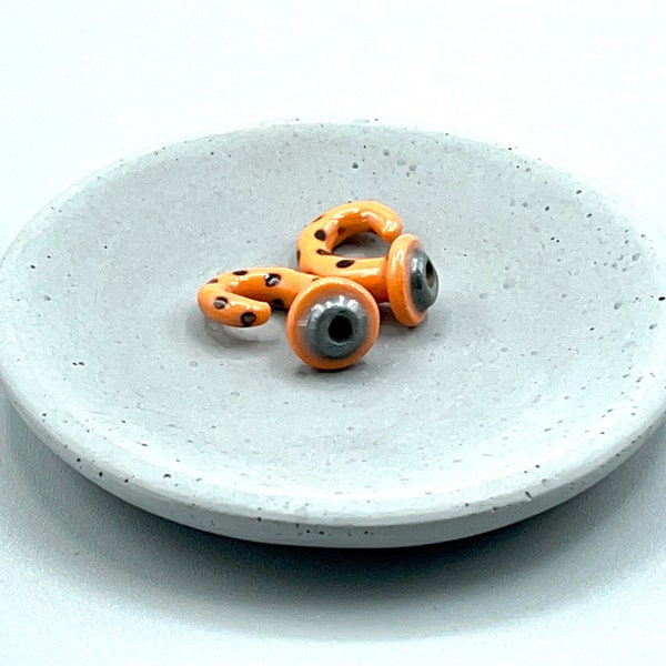 2 gauge ceramic earrings approximately 6 mm. Orange with black spots.