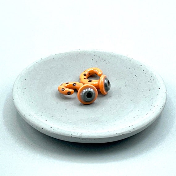 2 gauge ceramic earrings approximately 6 mm. Orange with black spots.