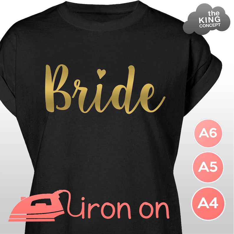 May include: Black t-shirt with gold iron-on lettering that says "Bride" with a small heart above the word. The t-shirt is available in A4, A5, and A6 sizes.