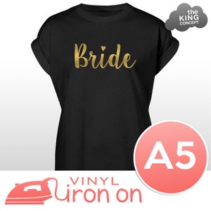 May include: A black t-shirt with the word "Bride" in gold glitter iron-on vinyl. The shirt is size A5 and is for iron-on vinyl.
