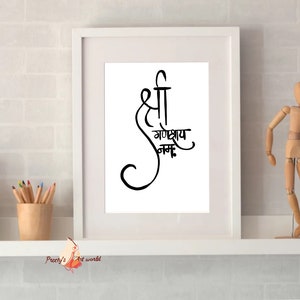 May include: A white framed print with black calligraphy that reads "Shree Ganeshay Namah". The print is on a white shelf with a wooden figurine and a vase of pencils.