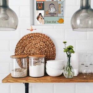May include: A colourful poster with a collage of images and text about chai. The poster features a teapot, cups of tea, spices, and the words "Chai Addict", "Masala Chai", and "I love chai".