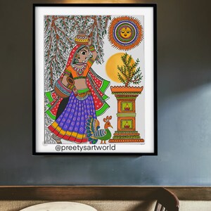 May include: A colorful folk art painting depicting a woman in a purple and green sari carrying a pot on her head, standing near a small shrine with a peacock and a sun with a face. The painting is signed "@preetyartworld".