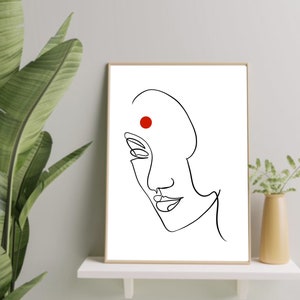 May include: A black and white line drawing of a woman's face with a red dot on her forehead. The drawing is in a simple, minimalist style.