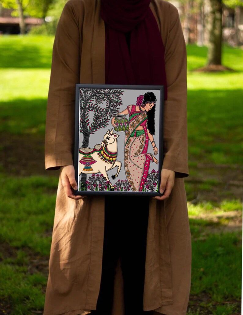 May include: A framed illustration of a woman in a colorful sari carrying a pot, walking with a decorated cow in a green field. The artwork is done in a folk art style with intricate details.